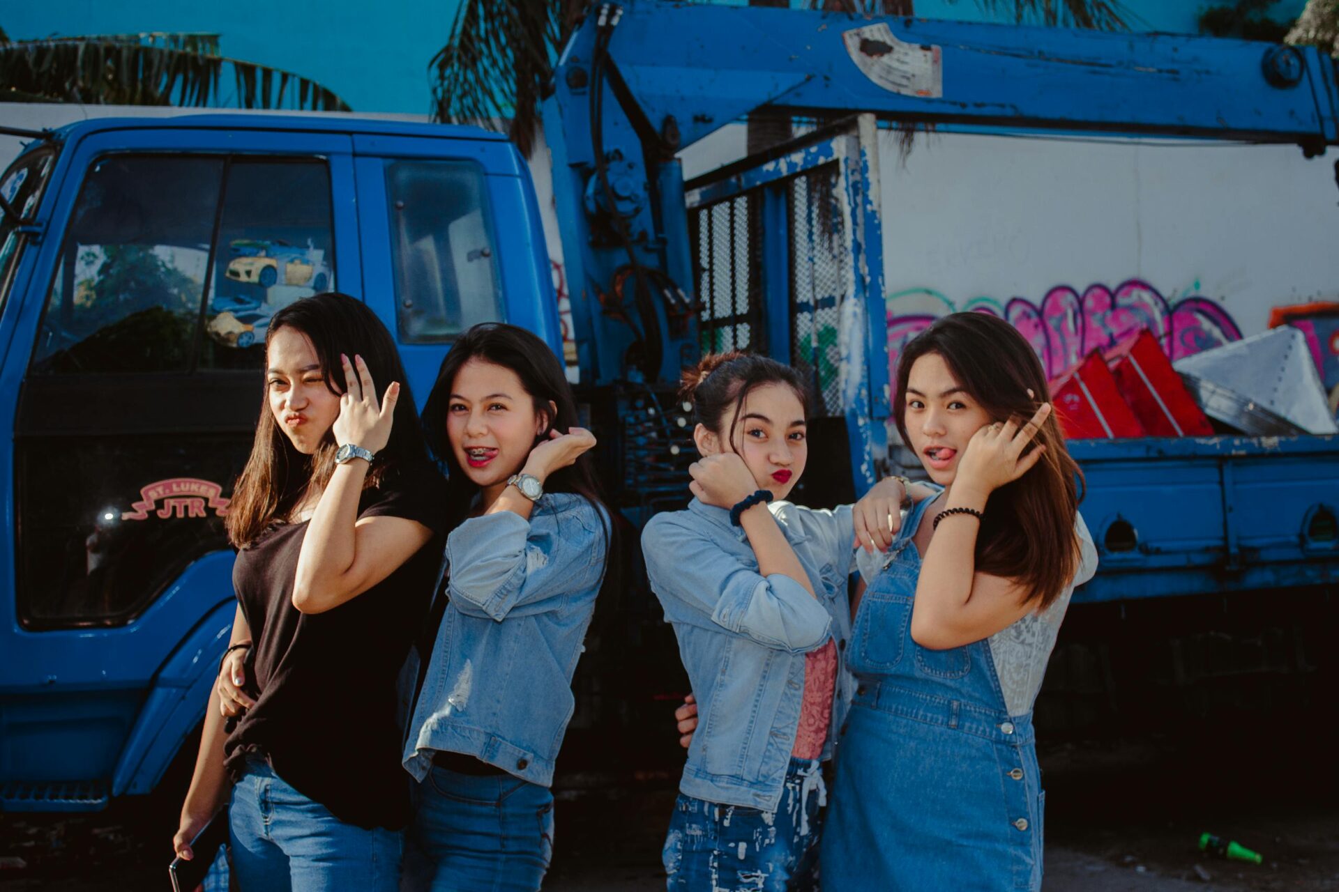 Young Women In Casual Wear Standing In Front Of A Truck