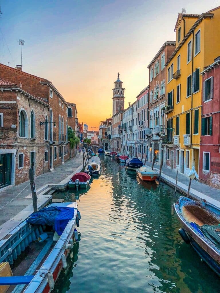 Canal street in Venice with colorful buildings and boats