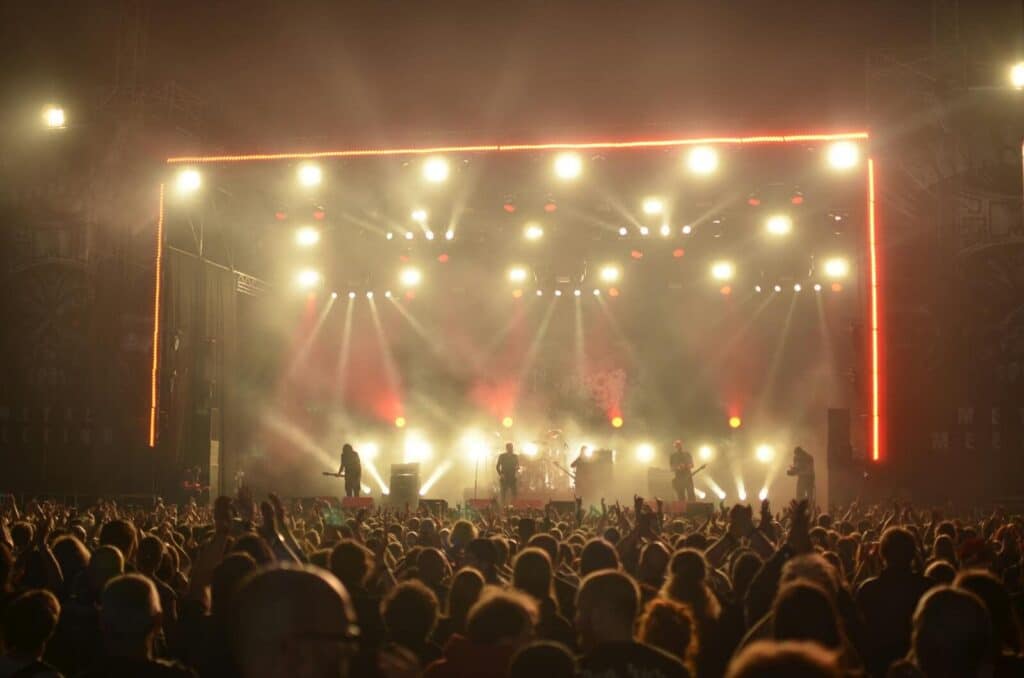 Concert stage with lights and crowd at night festival