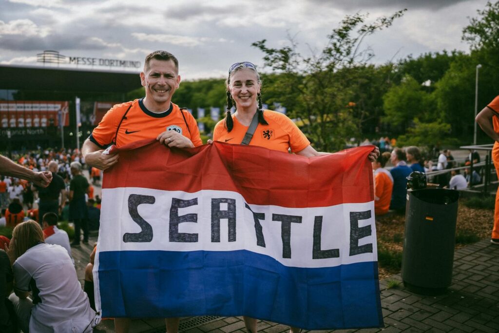Football fans holding a Seattle flag during a matchday