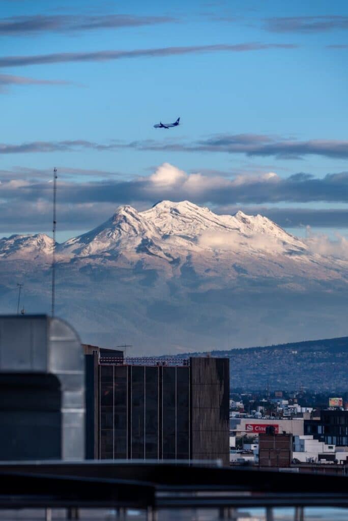 World Cup 2026 Weather Explained: What to Expect in All 16 Host Cities 9 Mexico City skyline with mountains in the background showing high altitude conditions during the World Cup 2026