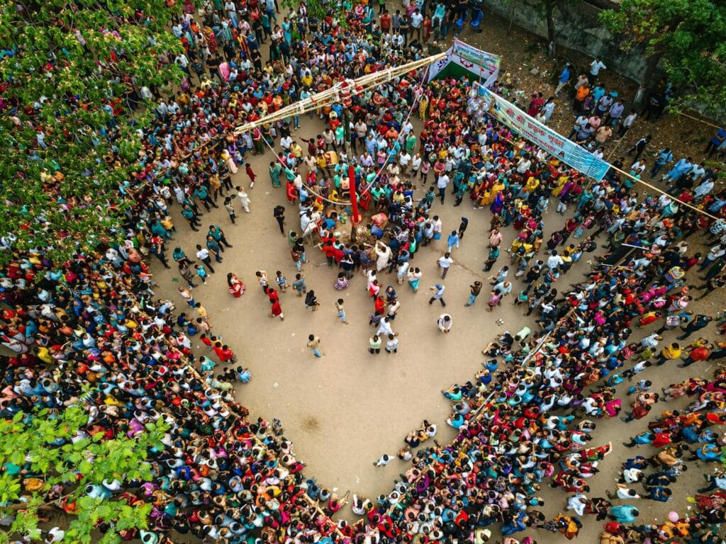 Large crowd gathered in an open space during a football fan event