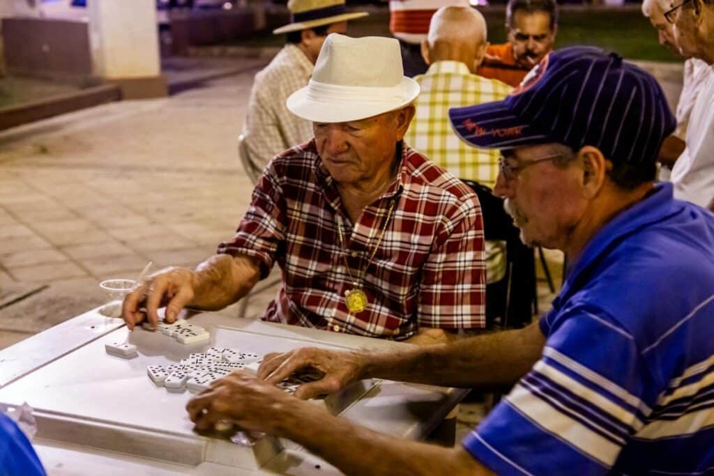 Men playing dominoes at Domino Park in Little Havana Miami