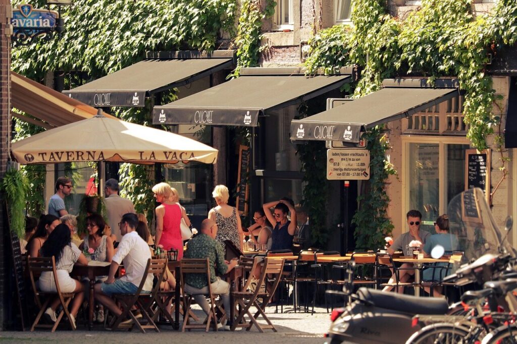 Top Things to Do in Vancouver During the World Cup 2026 11 Outdoor cafes and terraces on Commercial Drive in Vancouver with people enjoying the atmosphere