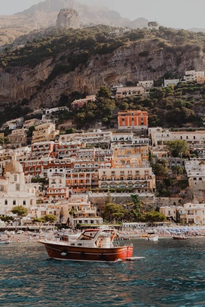 Boat near Positano on the Amalfi Coast with steep cliffs and buildings
