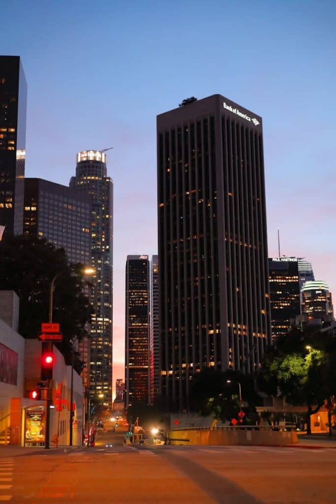Downtown Los Angeles street with skyline buildings at dusk