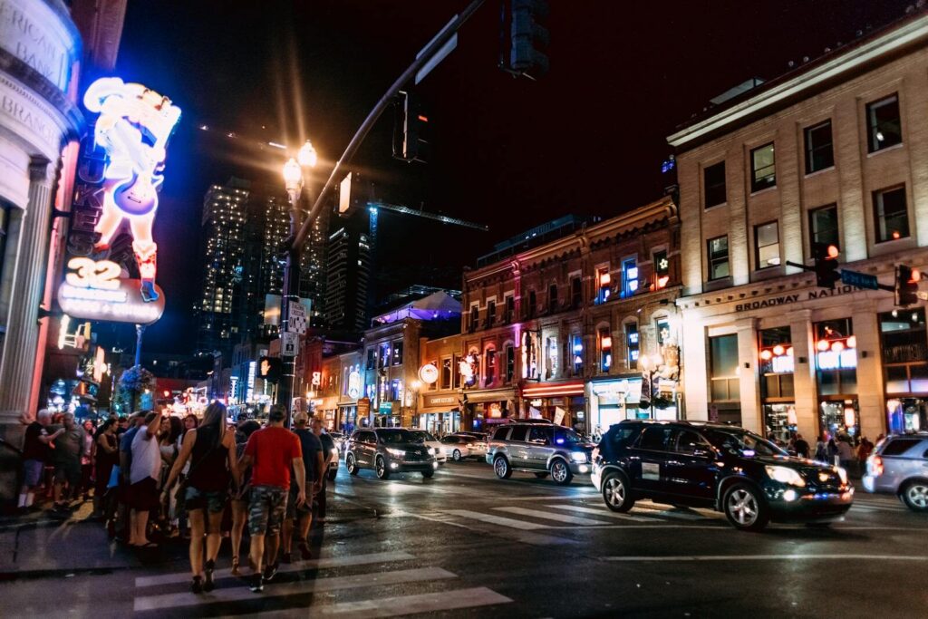 Top Things to Do in Dallas During the World Cup 2026 7 Deep Ellum nightlife in Dallas with neon lights, bars, and crowds along Elm Street at night