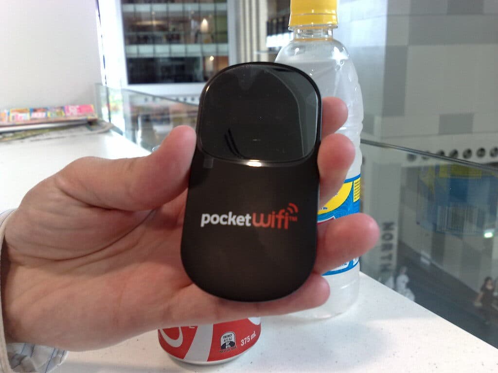 Hand holding portable pocket WiFi device for travel