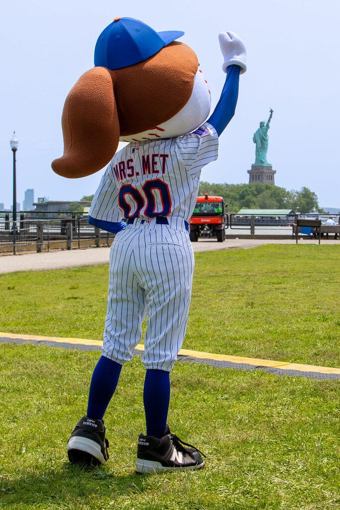 Top Things to Do in New York City During the World Cup 2026 4 Baseball mascot with Statue of Liberty in the background near Liberty State Park in New Jersey