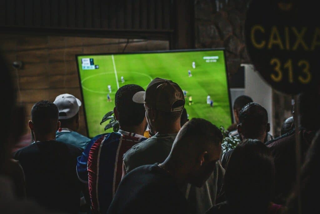 Best Places to Watch World Cup 2026 Matches Live: Top Spots If You Have No Ticket 5 Fans watching a football match on a TV inside a crowded sports bar