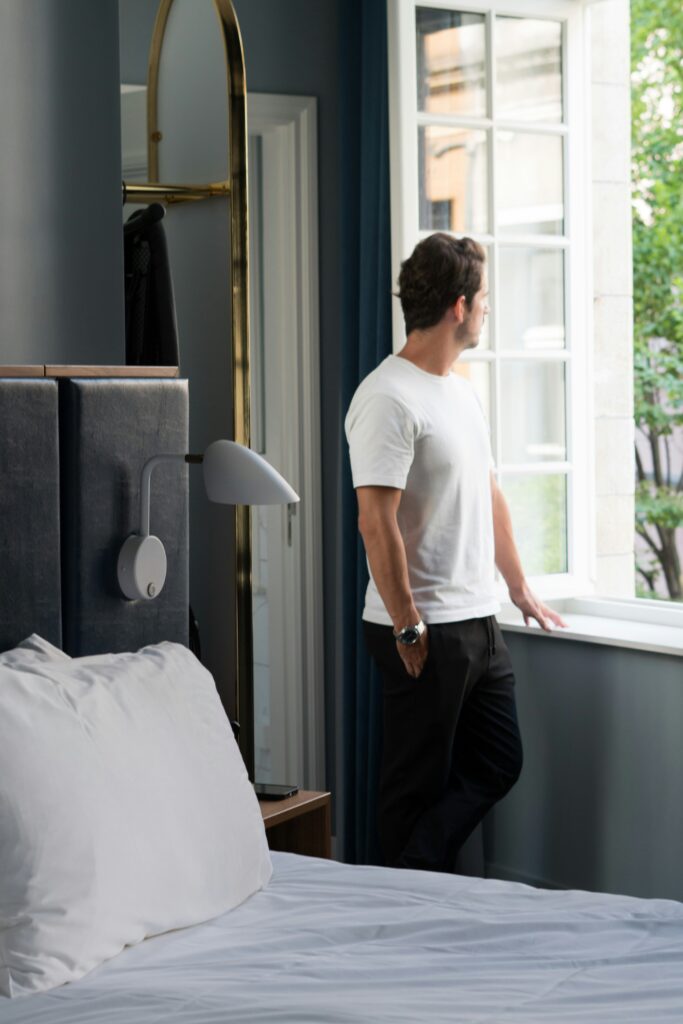 Traveller standing in a hotel room looking out the window during the World Cup 2026 Travel Guide