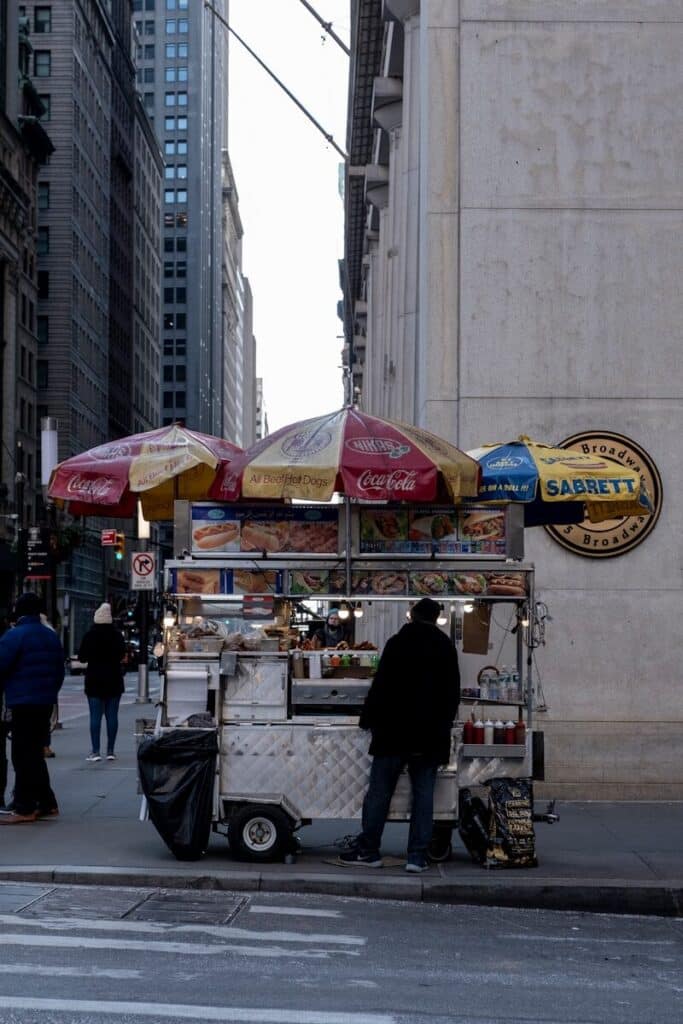 Top Things to Do in New York City During the World Cup 2026 14 New York street hot dog stand with vendor and classic city buildings in the background