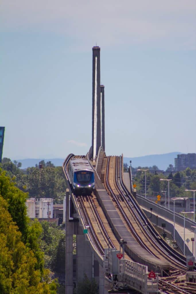 Uber vs Public Transport for World Cup 2026? Avoid Surge Pricing and Overpriced Stadium Trains 10 SkyTrain in Vancouver running on an elevated track, showing efficient public transport during the World Cup 2026