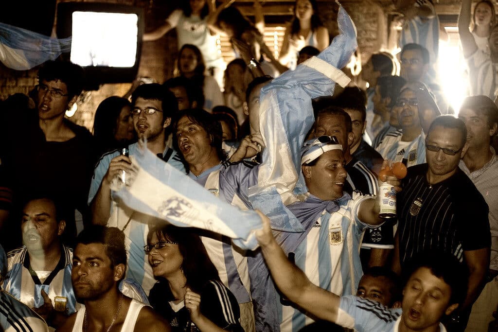 Top Things to Do in New York City During the World Cup 2026 7 Group of football fans cheering and watching a match together inside a crowded bar