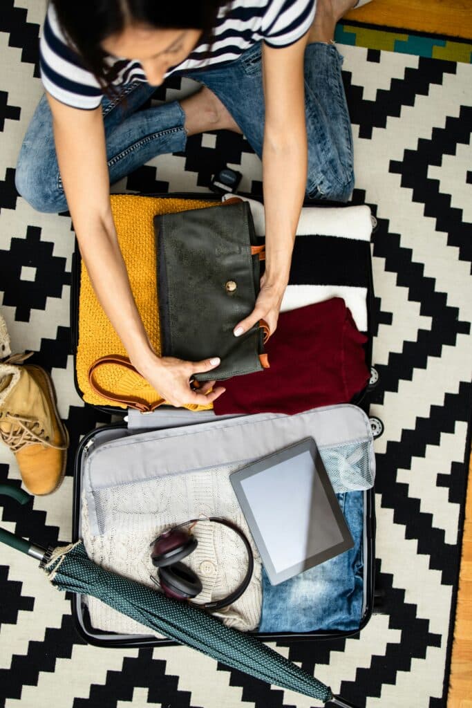 Packing a suitcase with organized travel items — preparing safely for World Cup 2026 travel