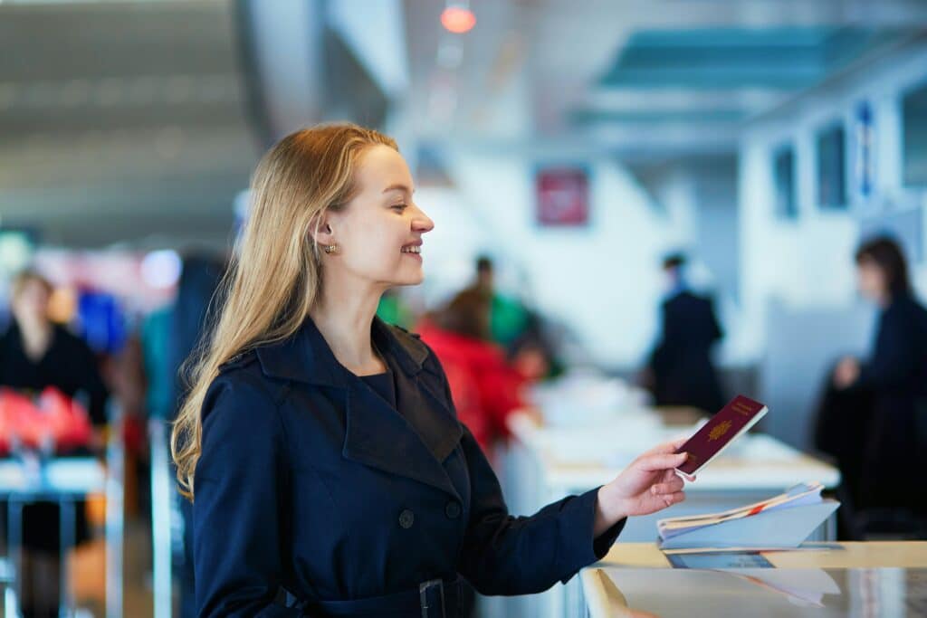 Traveler presenting passport at airport security — essential documentation for safe World Cup 2026 travel