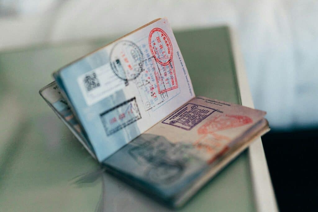 How to Plan a Last-Minute World Cup 2026 Trip (8-Week Countdown) 6 Open passports with visa stamps placed on a table for travel documentation