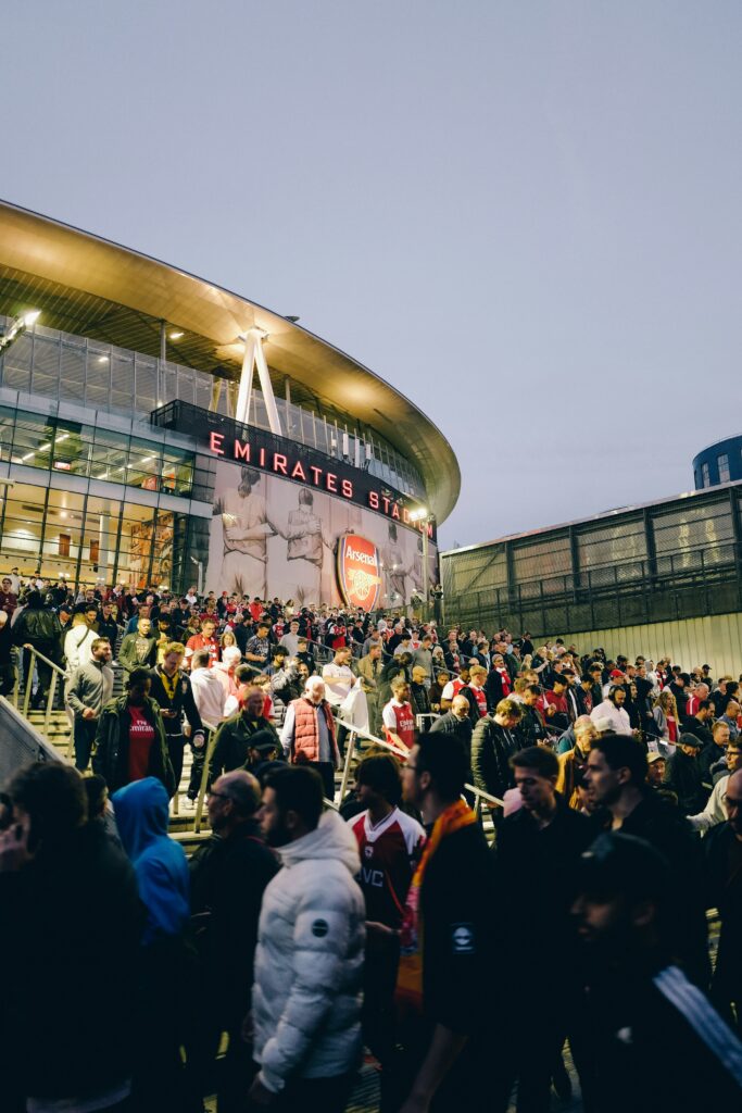 Uber vs Public Transport for World Cup 2026? Avoid Surge Pricing and Overpriced Stadium Trains 1 Crowds leaving a packed stadium after a football match, illustrating post-event transport congestion and surge pricing risk
