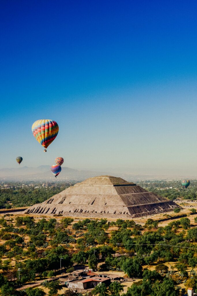 Hot air balloons floating above Teotihuacan pyramids near Mexico City