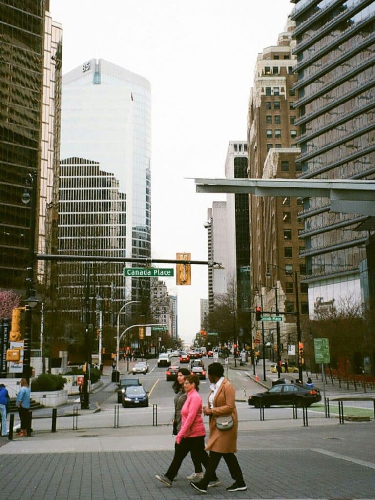 Uber vs Public Transport for World Cup 2026? Avoid Surge Pricing and Overpriced Stadium Trains 11 People walking in downtown Vancouver near Canada Place, showing how accessible and walkable the city is during the World Cup 2026