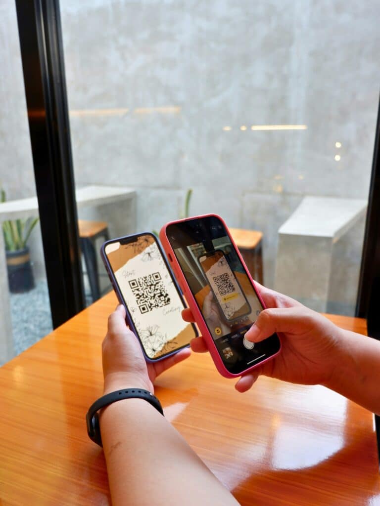 Scanning a QR code on a smartphone to install an eSIM before traveling