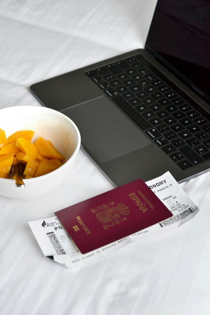 Passport and boarding pass on a bed — essential travel documents for World Cup 2026 trip preparation