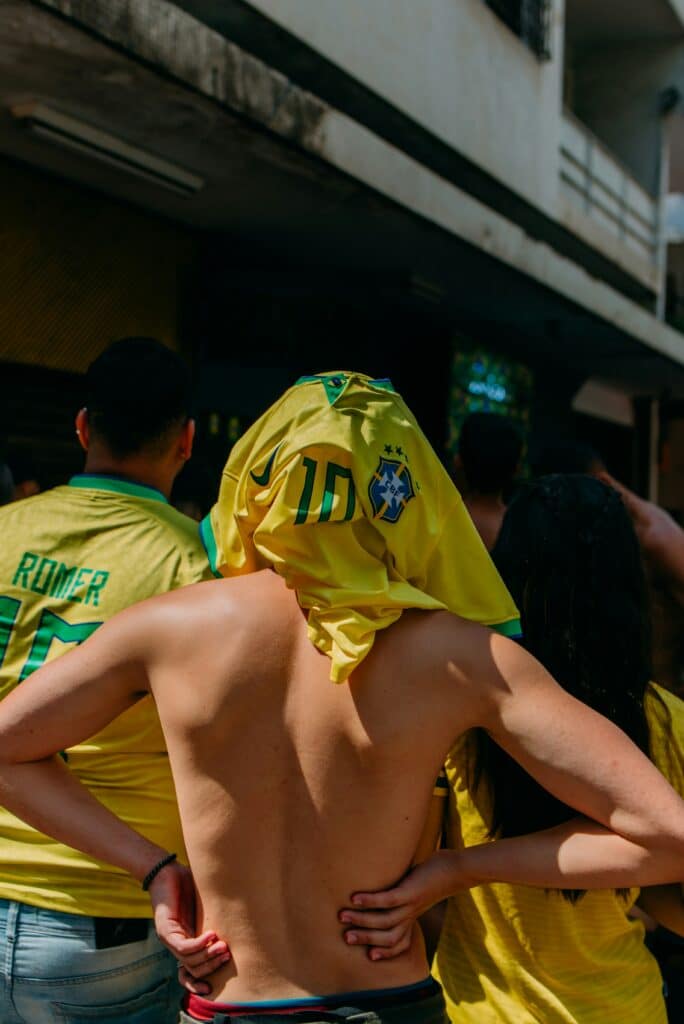 World Cup 2026 Weather Explained: What to Expect in All 16 Host Cities 4 Football fans dealing with extreme heat using clothing for sun protection during a hot day