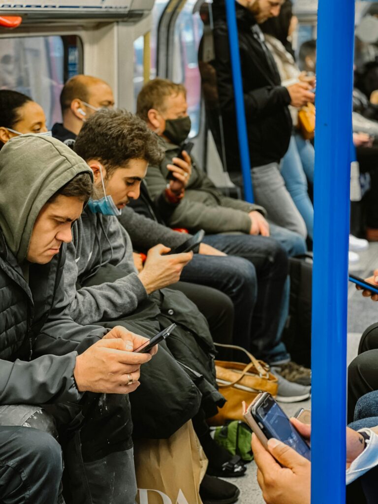 How Much Mobile Data Do You Need at the FIFA World Cup 2026? (Without Overpaying) 2 People watching videos on smartphones during public transport commute — high mobile data usage while travelling