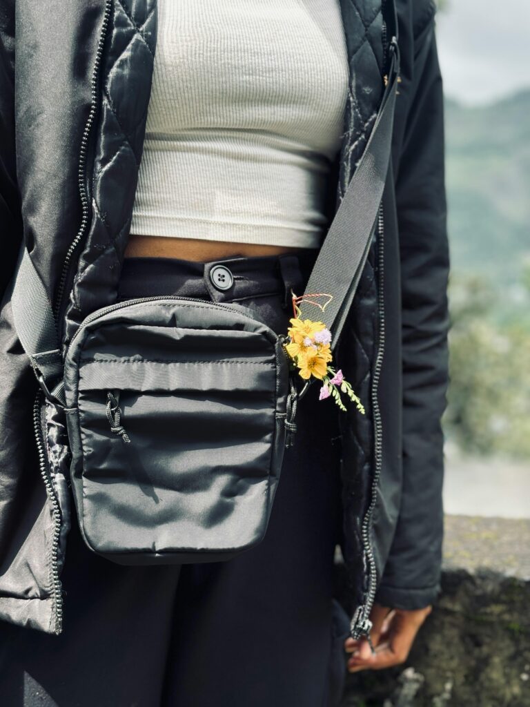 Small crossbody bag worn by a traveller, suitable for stadium entry rules