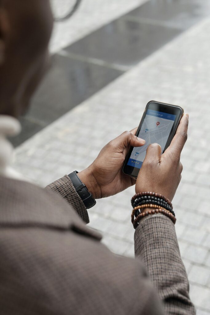 Traveler using a smartphone with a navigation app to find directions in a city