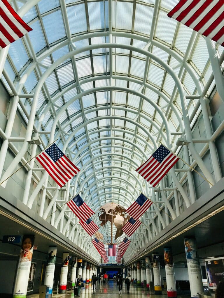Airport terminal with American flags and travellers arriving for the World Cup 2026 Travel Guide