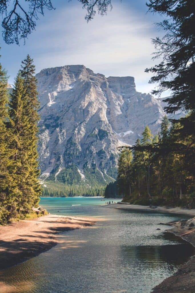 Mountain lake in the Dolomites surrounded by forest and peaks in northern Italy