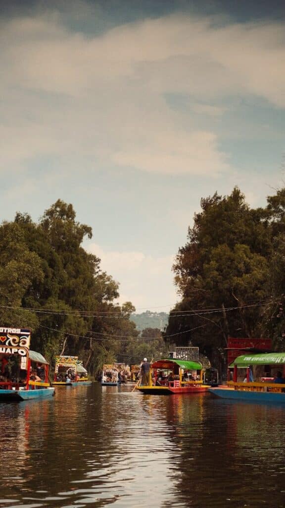 Colorful trajineras boats with people on the canals of Xochimilco in Mexico City