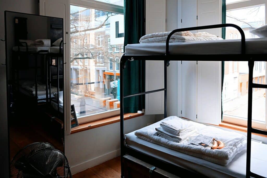 How to Plan a Last-Minute World Cup 2026 Trip (8-Week Countdown) 9 Hostel room with bunk beds and window light as a budget accommodation option