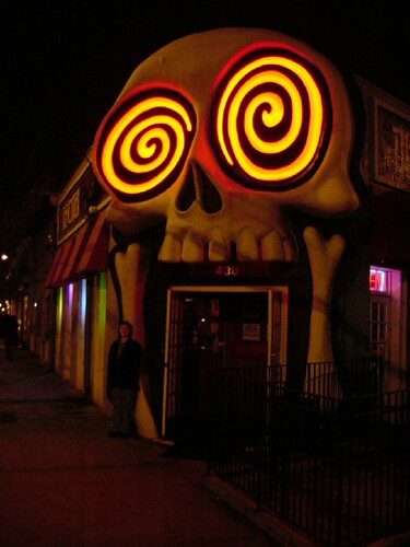quirky skull-shaped bar entrance with glowing spiral eyes on a street in Little Five Points Atlanta at night — one of the top things to do in Atlanta for nightlife