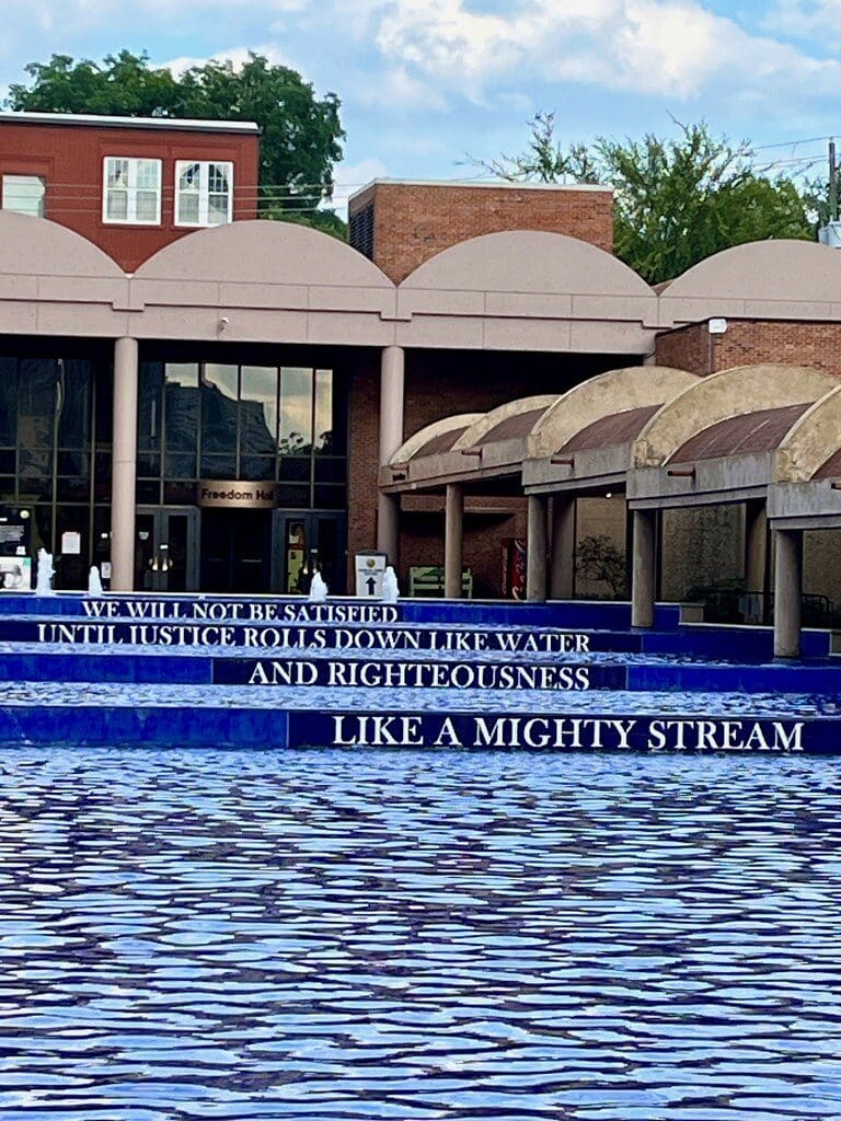 reflecting pool at the MLK Center in Atlanta with civil rights quote inscribed on the blue tile wall