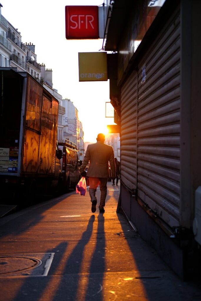 eSIM or Physical SIM in France? Pros, Cons & Best Pick for Travellers 2026 4 Orange mobile store in Paris with woman standing at bus stop outside