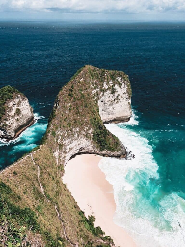 aerial view of Kelingking Beach on Nusa Penida with dinosaur-shaped cliff and turquoise water