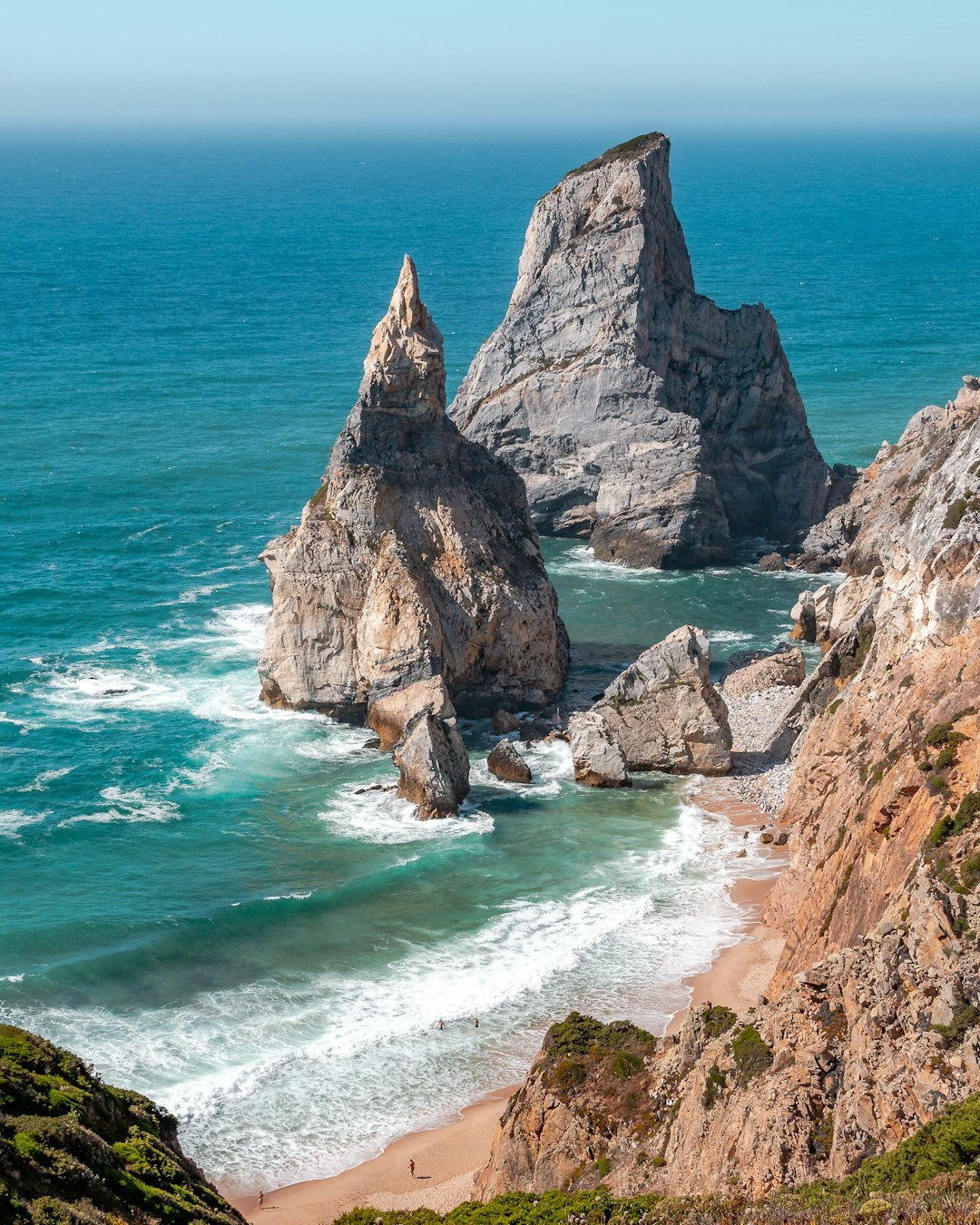 Best Beaches in Portugal: A Guide to the Country's Top Coastal Spots 24 Large rock formations resting on a sandy Portuguese beach