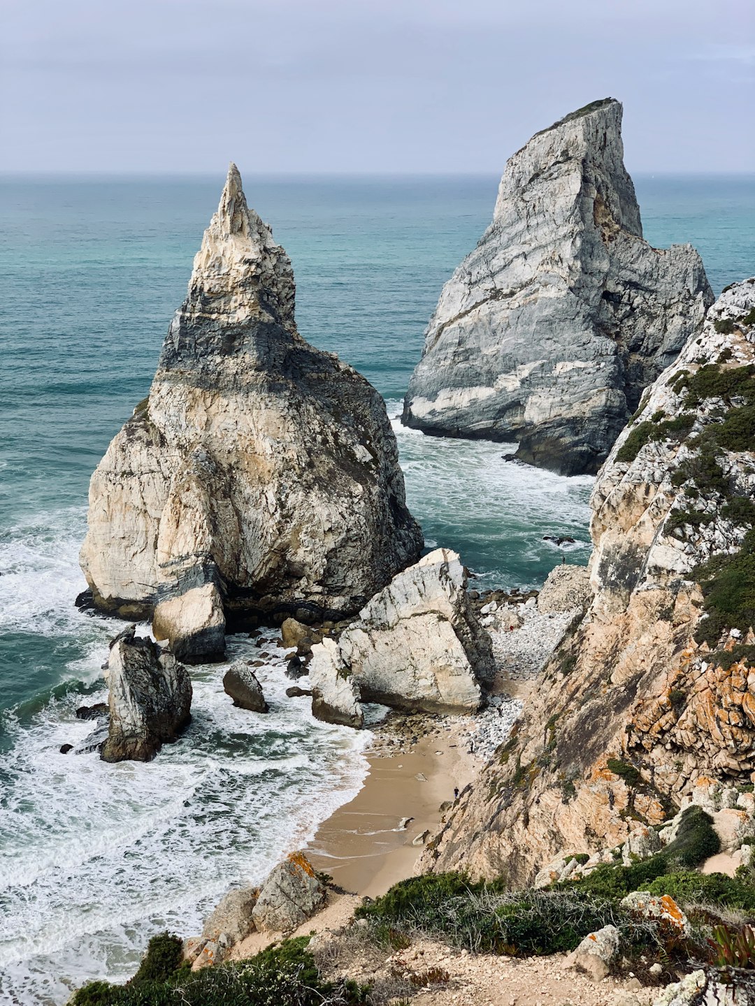 Best Beaches in Portugal: A Guide to the Country's Top Coastal Spots 36 Rocky cliff overlooking calm water along the Portuguese coast