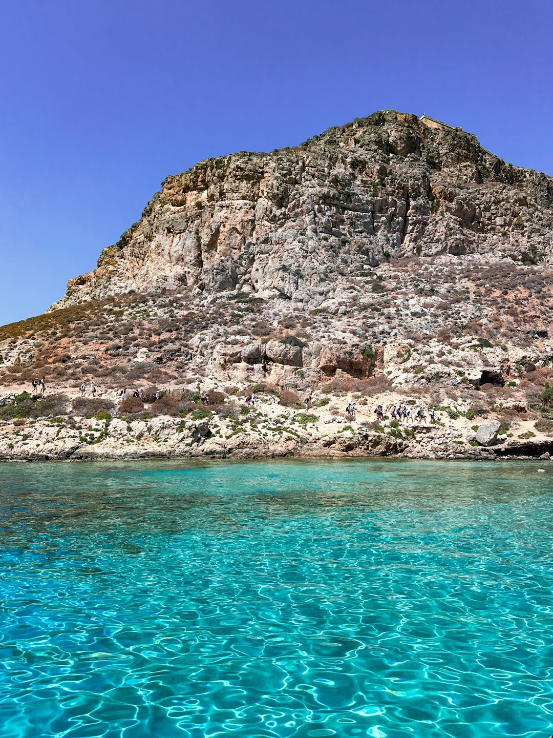 Rocky cliffs meet crystal-clear water in Crete, among the best islands greece has