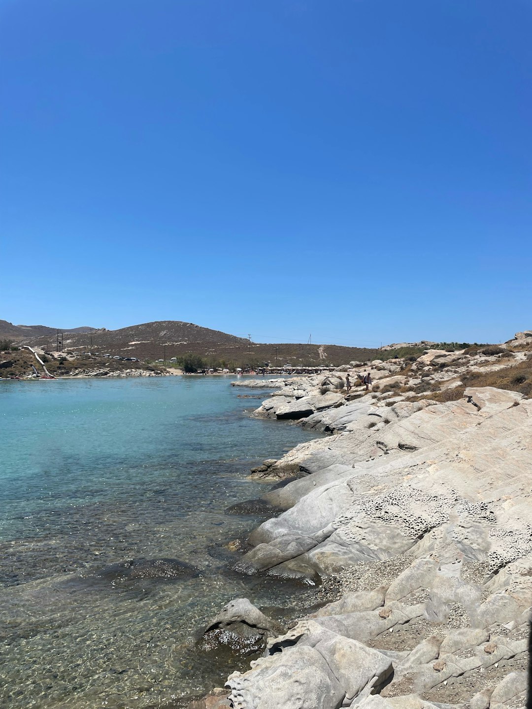 Rocky beach in Crete with calm water stretching toward the horizon
