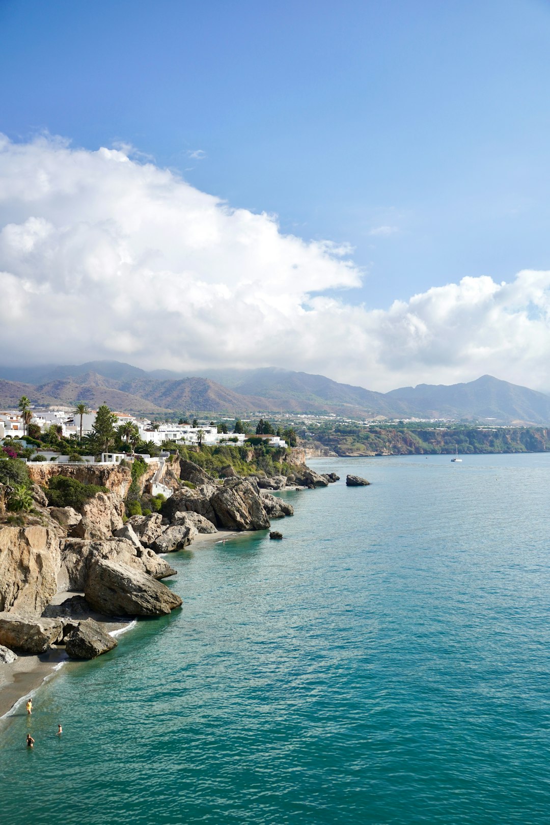 Whitewashed coastal town built on rocky cliffs above the sea