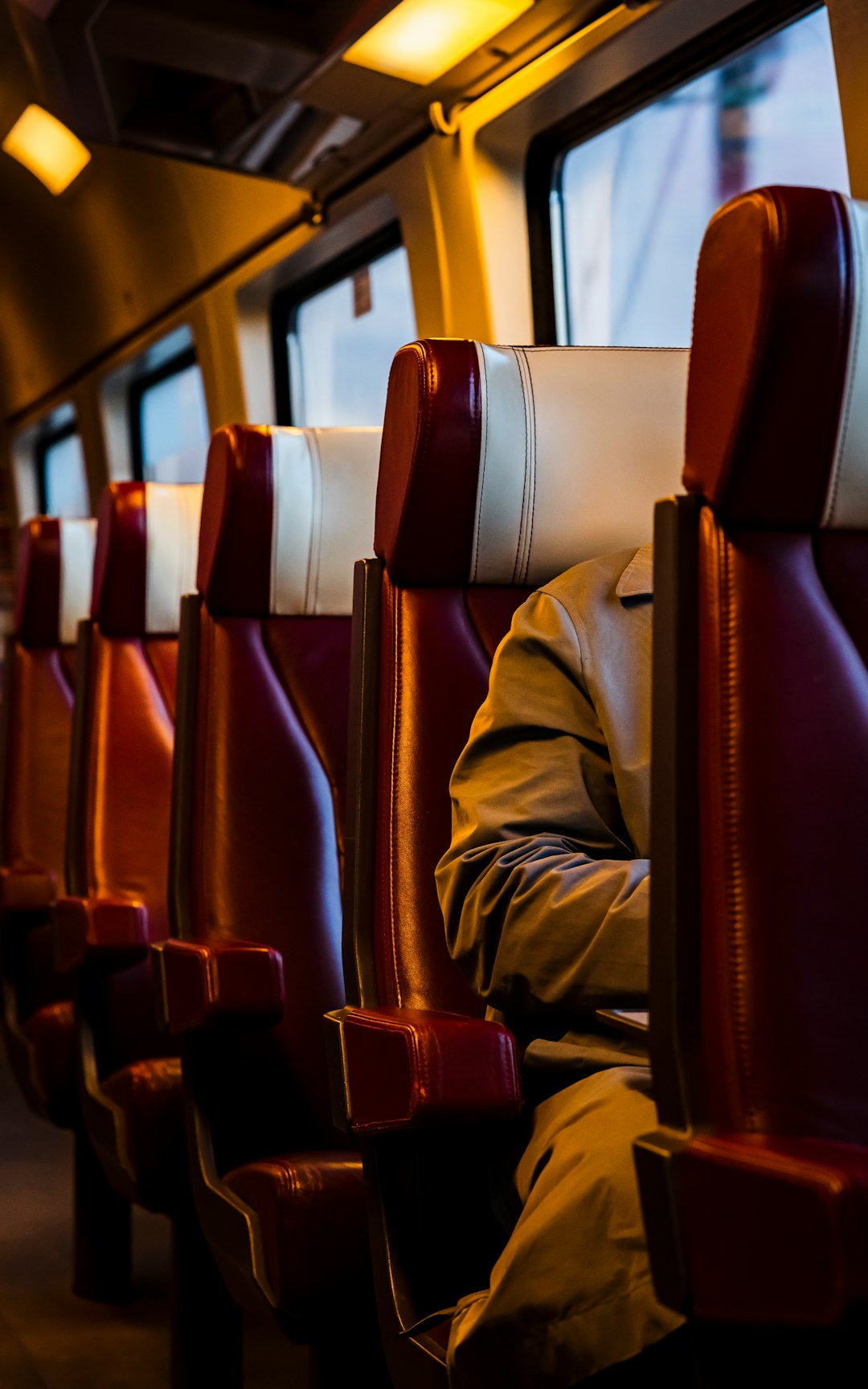 Man working on a laptop while riding a bus in Europe