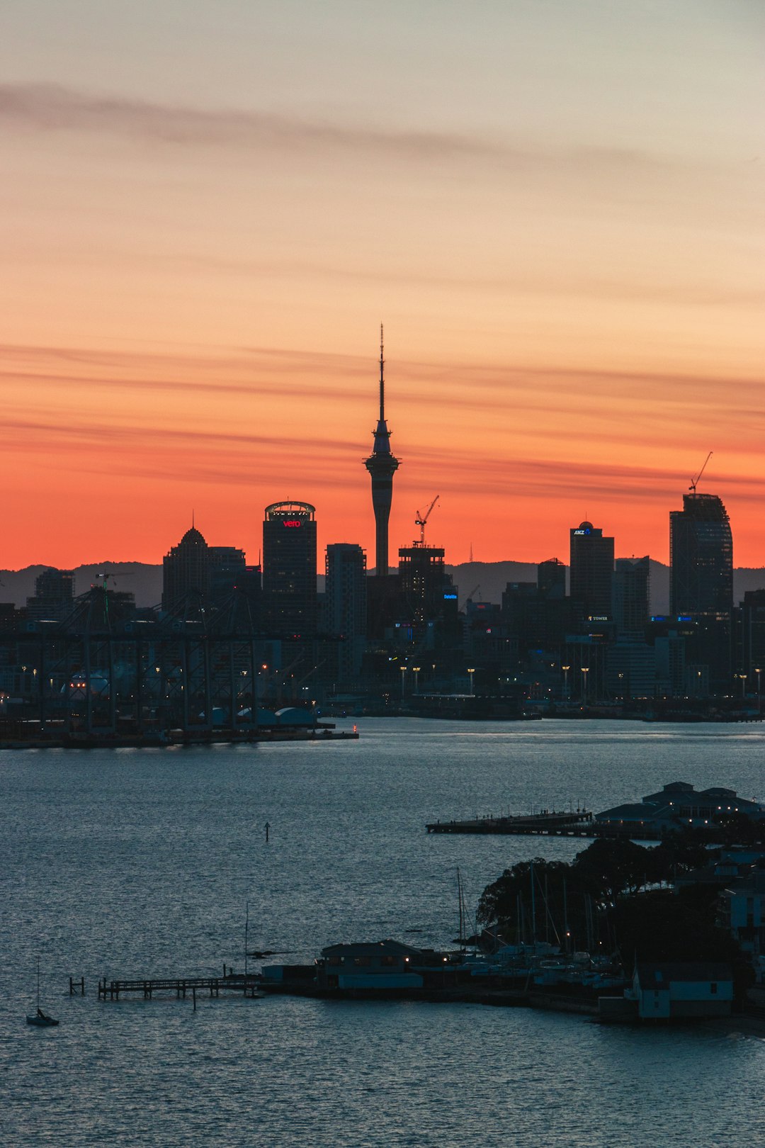 Best Internet Options for Travellers in New Zealand (2026) 18 city skyline silhouetted against an orange sunset