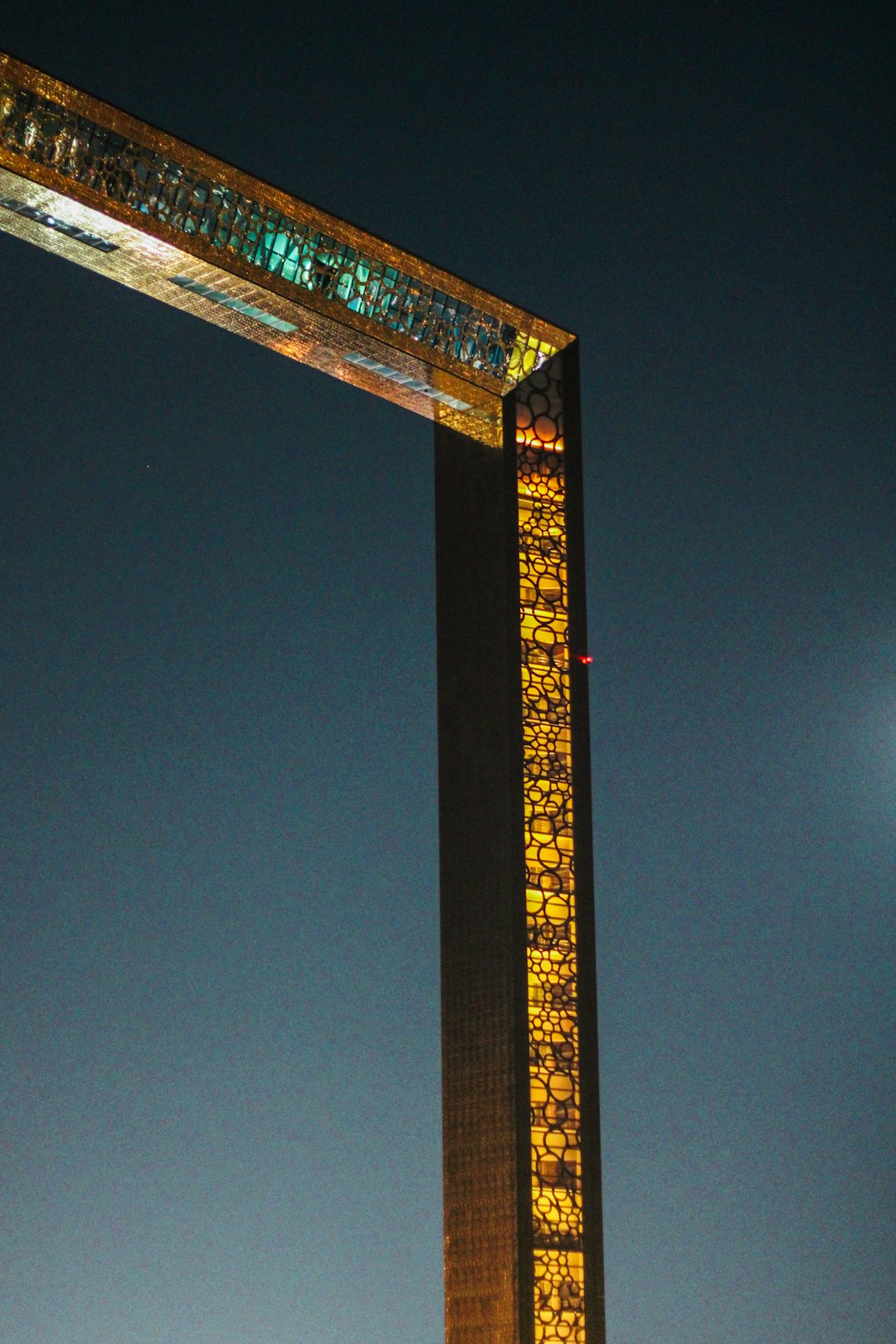 modern illuminated skyscraper against a night sky in Dubai