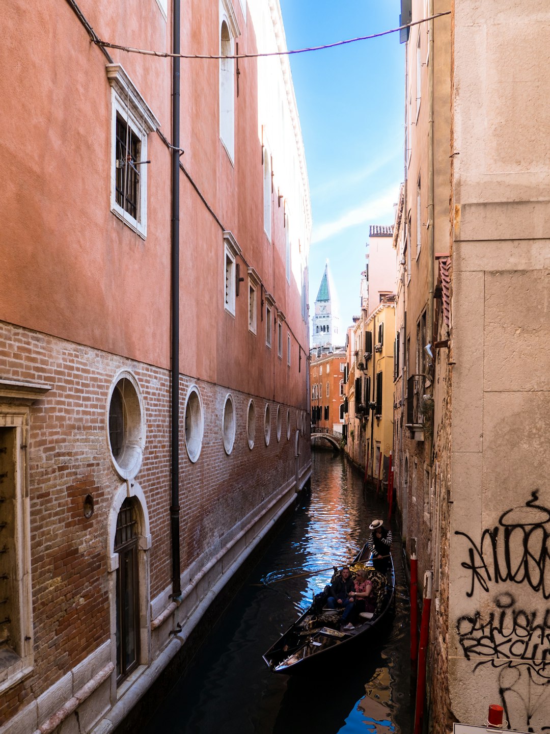 People in a canoe passing near the Bridge of Sighs