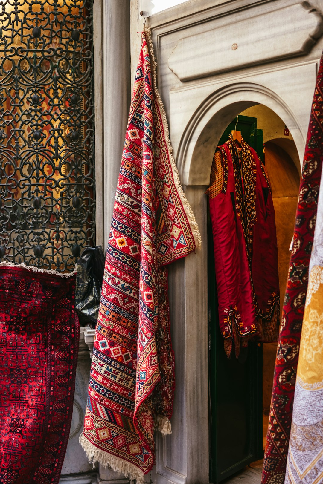 row of neckties hanging from a door