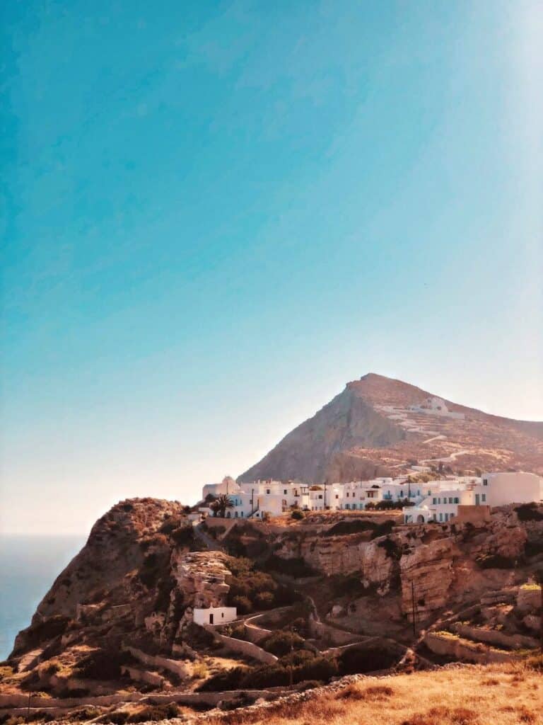 white hilltop village of Folegandros Chora perched on rocky cliffs above the Aegean Sea