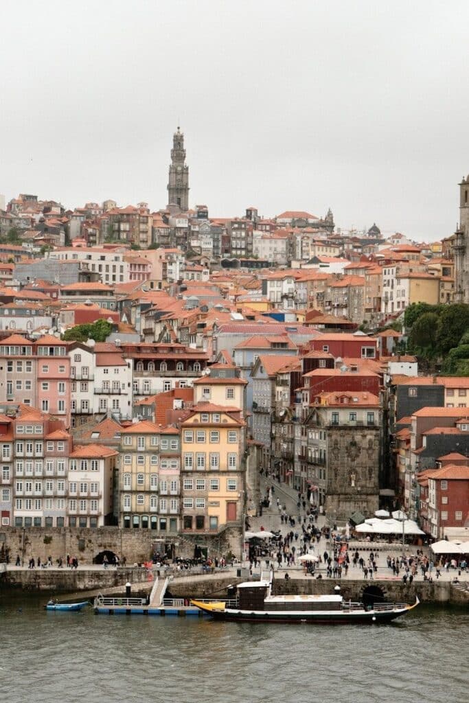 eSIM Portugal vs Roaming: Best Way to Stay Connected as a Traveler in 2026 7 Porto Ribeira waterfront with colourful buildings and the Clerigos tower in the background